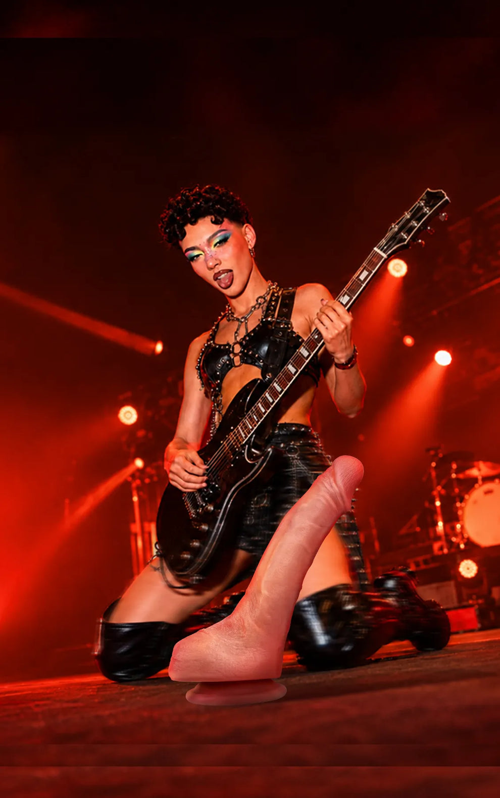 Jessie realistic platinum silicone dildo with guitarist performing under red stage lights