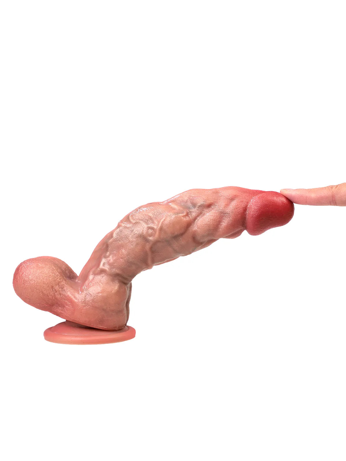 Finger pressing the tip of the Coach dildo